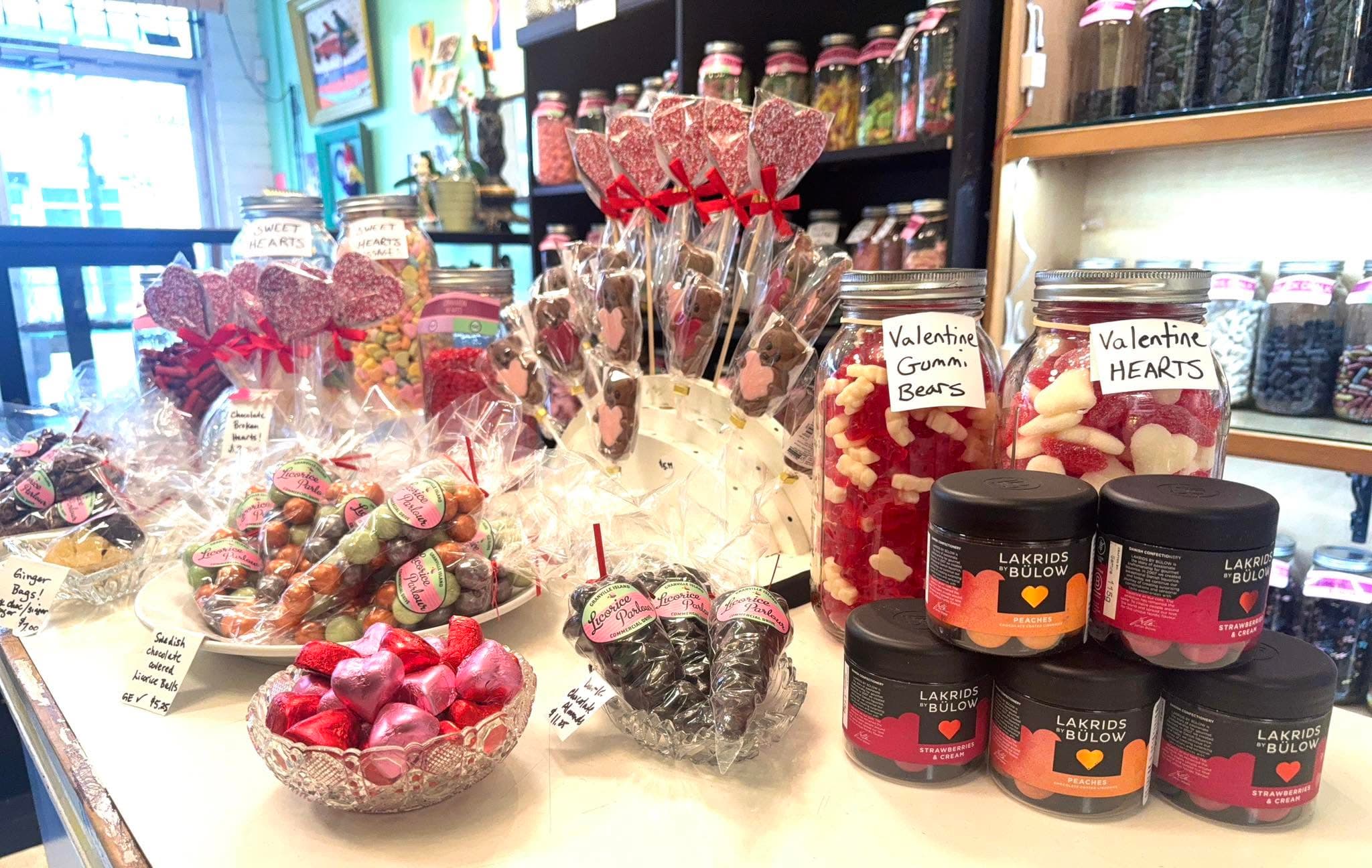 Candy counter with wrapped treats, jars, chocolates, and licorice