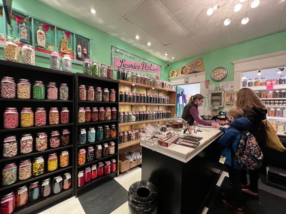 Inside The Licorice Parlour with candy jars and customers at the counter
